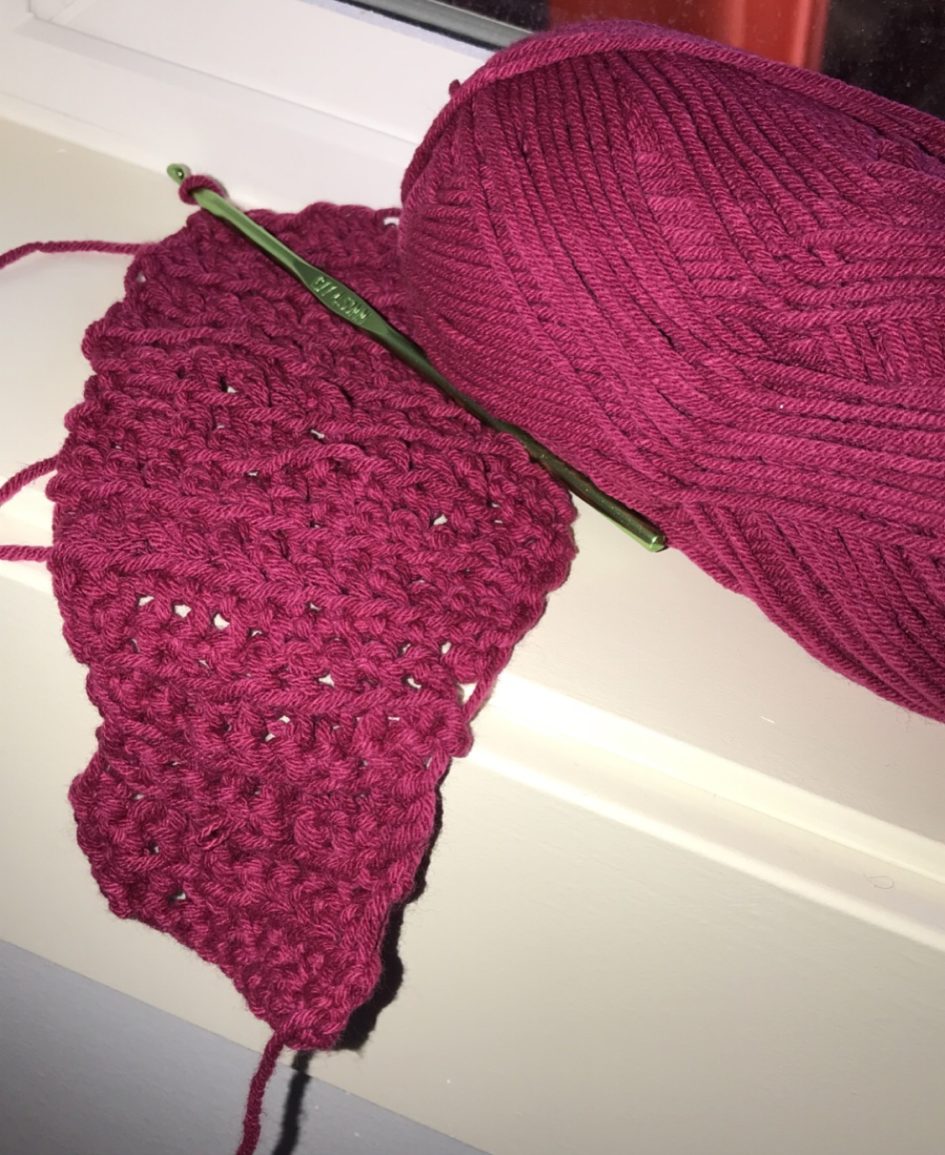 ball of yarn and practiced crochet pattern
